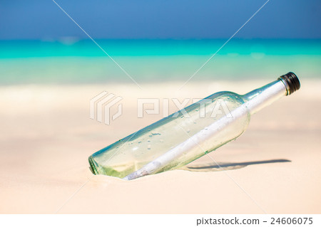Bottle with a message buried in the white sand Bottle with a message buried in the white sand 24606075