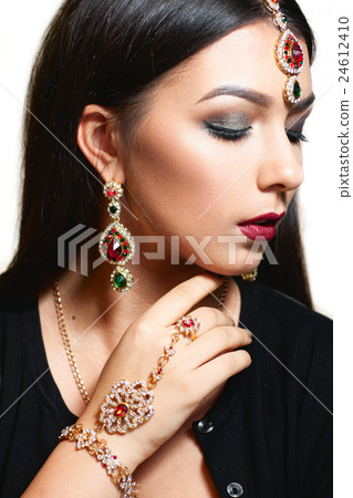 Gorgeous woman with luxurious jewelry close-up 24612410