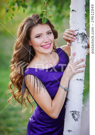 Woman standing near birch tree in summer day Woman standing near birch tree in summer day 24612849