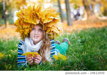 beautiful woman with a wreath of yellow leaves in 24612930