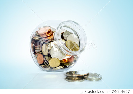 Money in the glass bottle on wooden table. Money in the glass bottle on wooden table. 24614607