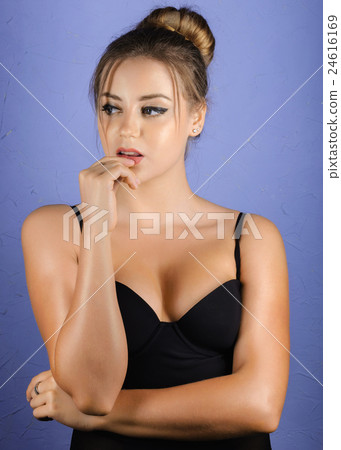 elegant girl with tuft of hair is biting her lip elegant girl with tuft of hair is biting her lip 24616169