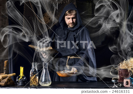 Halloween magician is preparing for magical ritual 24616331