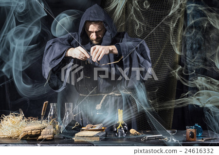 Halloween.  medieval alchemist holds magic ritual  24616332