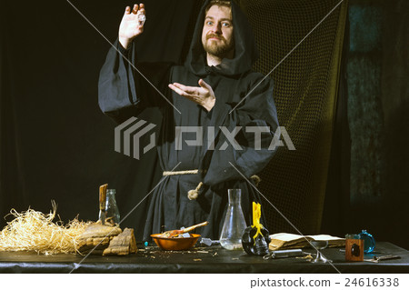 medieval scientist working in his laboratory 24616338