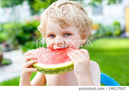 little toddler boy  eating healthy watermelon in 24617007