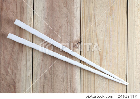 White chopsticks spoon on wood floor. White chopsticks spoon on wood floor. 24618487