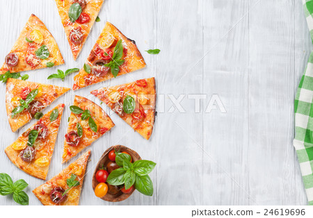 Pizza with tomatoes, mozzarella and basil Pizza with tomatoes, mozzarella and basil 24619696