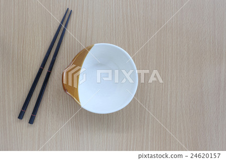 black chopsticks and cup in top view on wood. black chopsticks and cup in top view on wood. 24620157