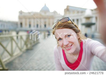 Beautiful young woman taking a picture of herself in Vatican 24621778