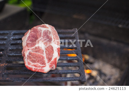 Juicy raw steak on barbecue background outdoor 24625113