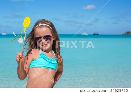 Adorable little girl at white beach during summer 24625750