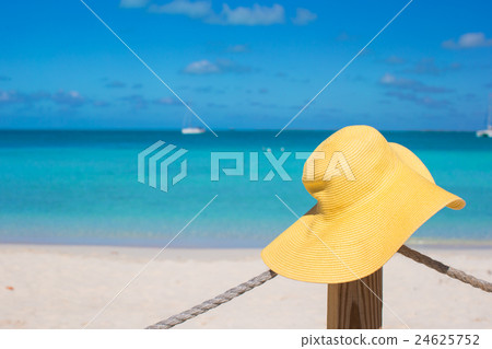 Yellow hat on the beach fence at caribbean island 24625752