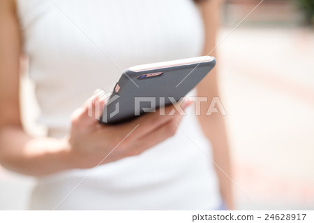 Woman using mobile phone Woman using mobile phone 24628917