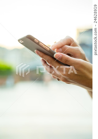 Woman sending sms on mobile phone Woman sending sms on mobile phone 24628919