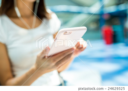 Woman listen to music by cellphone Woman listen to music by cellphone 24629325