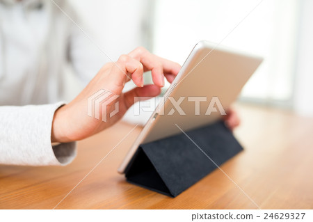 Woman using tablet computer at home Woman using tablet computer at home 24629327