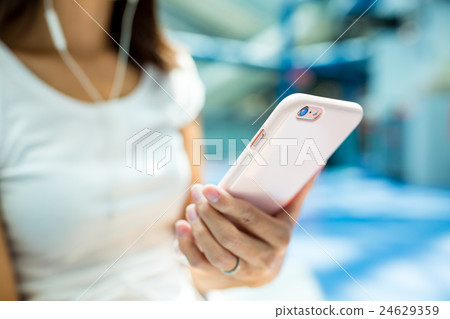 Woman listen to music by mobile phone 24629359