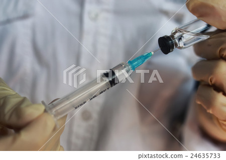 nurse hands holding syringe and ampoule 24635733
