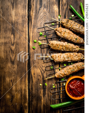 Kebab with tomato sauce and green onions. Kebab with tomato sauce and green onions. 24641623