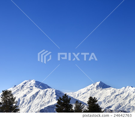Snowy mountains and blue clear sky at sun morning 24642763