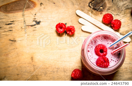 Berry smoothie raspberry with wooden sticks. Berry smoothie raspberry with wooden sticks. 24643790