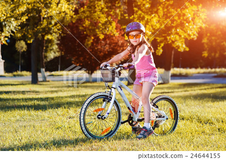 Child riding a bicycle. The kid in helmet on bike 24644155