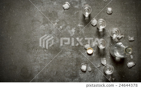 bottle of vodka with glasses and ice. 24644378