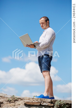 Happy business man looking to his laptop 24644411