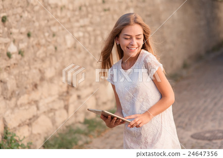 Elegant young woman using tablet 24647356