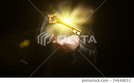 businessman hold a gold shining key businessman hold a gold shining key 24648651