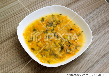 plate of pea soup is on the table plate of pea soup is on the table 24650112