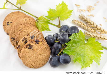 Integral cookies with grapes on white 24650679