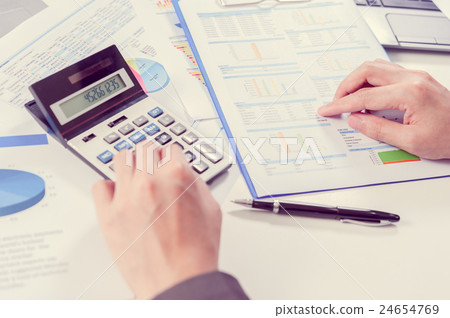 Businessman using calculator analyze report 24654769