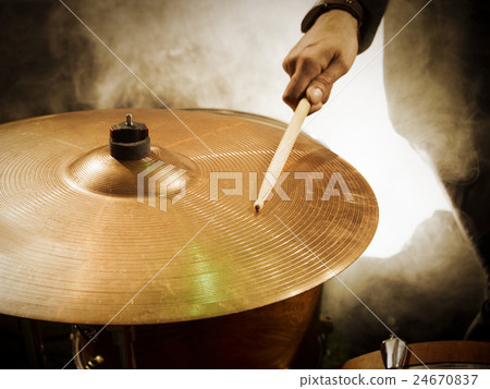 Drummer hitting sticks in ride. 24670837