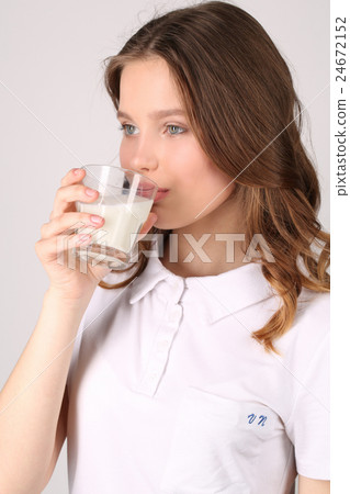 Lady drinking milk. Close up. White background Lady drinking milk. Close up. White background 24672152