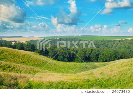picturesque hills, forest and blue sky picturesque hills, forest and blue sky 24673480