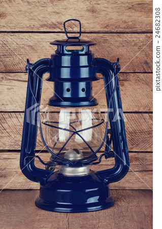kerosene lamp on wooden table 24682308