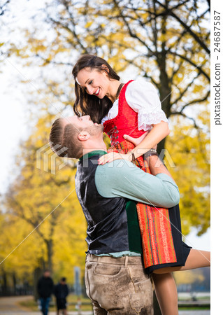 couple in Tracht in loving embrace with uplift 24687587