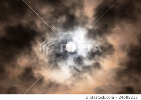 Menacing eye of the midday sun in cloudy sky Menacing eye of the midday sun in cloudy sky 24688218
