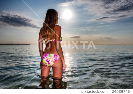 attractive sexy woman in bikini stand in calm sea attractive sexy woman in bikini stand in calm sea 24689746