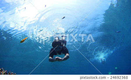 Men underwater snorkeling in Okinawa Akajima Men underwater snorkeling in Okinawa Akajima 24692368
