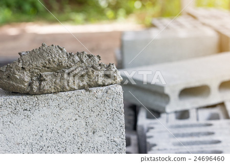 Cement mix with a trowel put on the brick Cement mix with a trowel put on the brick 24696460