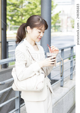 Business woman drinking iced coffee Business woman drinking iced coffee 24696883
