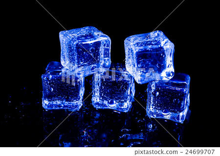ice cubes in blue light on a black table. ice cubes in blue light on a black table. 24699707