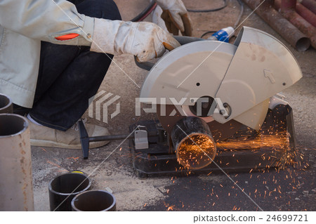 electric saw and hands of worker with sparks. 24699721