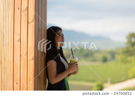 Beautiful asian women hold cup of ice mocha coffee Beautiful asian women hold cup of ice mocha coffee 24700852