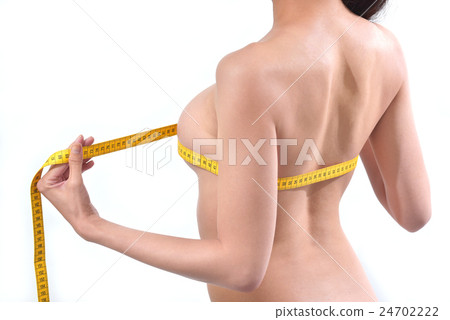 Young lady making beauty bust measurements Young lady making beauty bust measurements 24702222