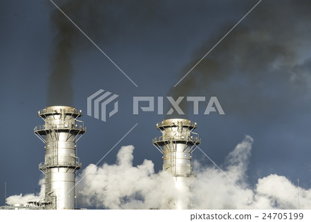 A factory chimney that produces black smoke 24705199