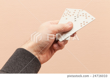 Male hand holds two hotel door key cards 24716010